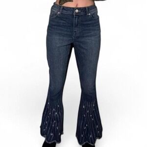Dark wash denim jeans with frayed hem and beaded details